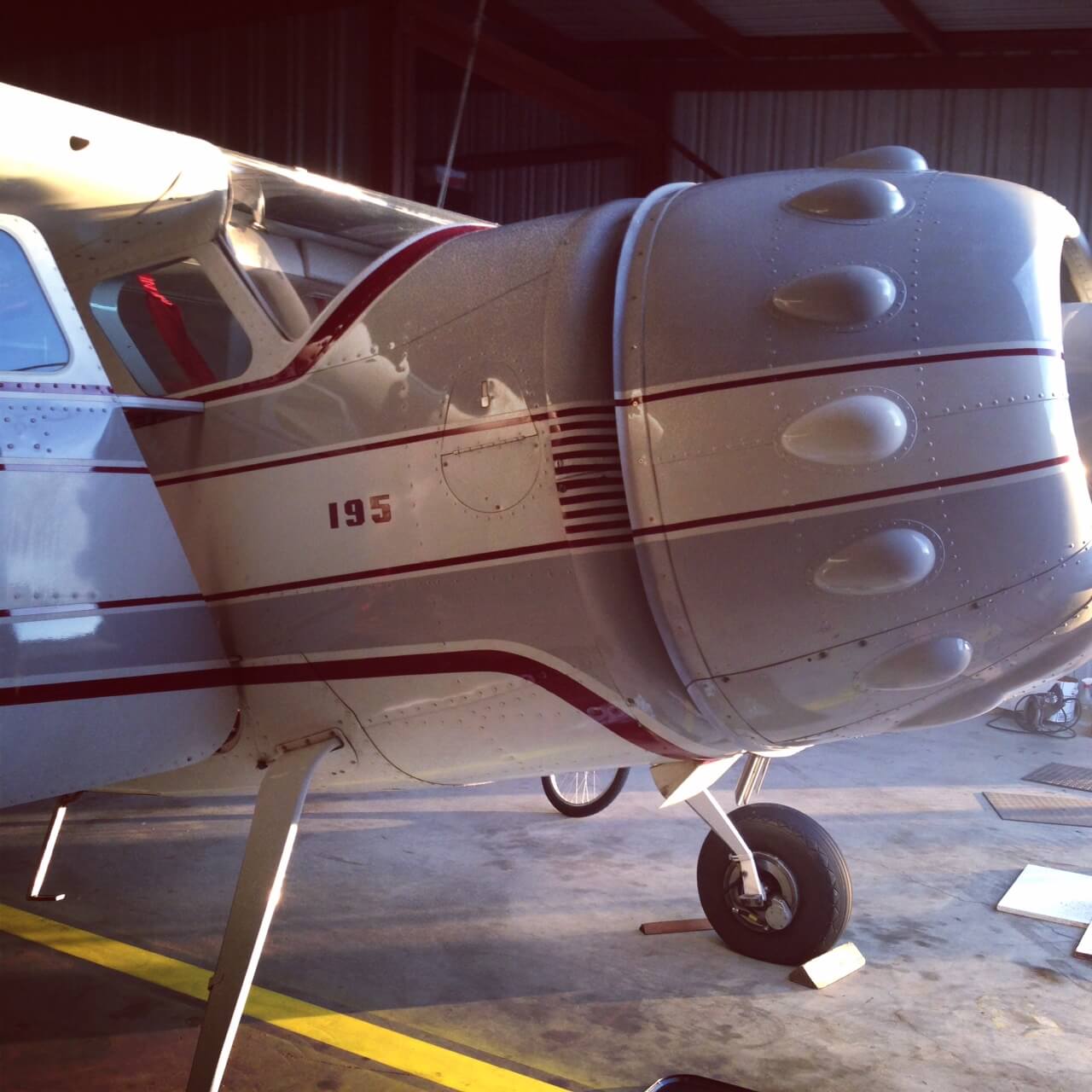 Cessna 195 in hangar